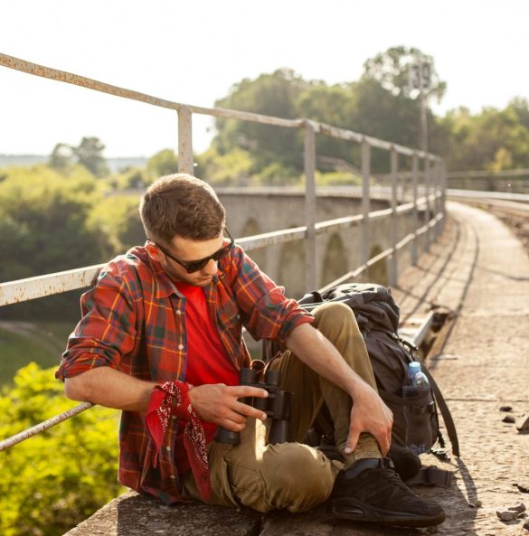 Portrait man at bridge with binocular resting (1)